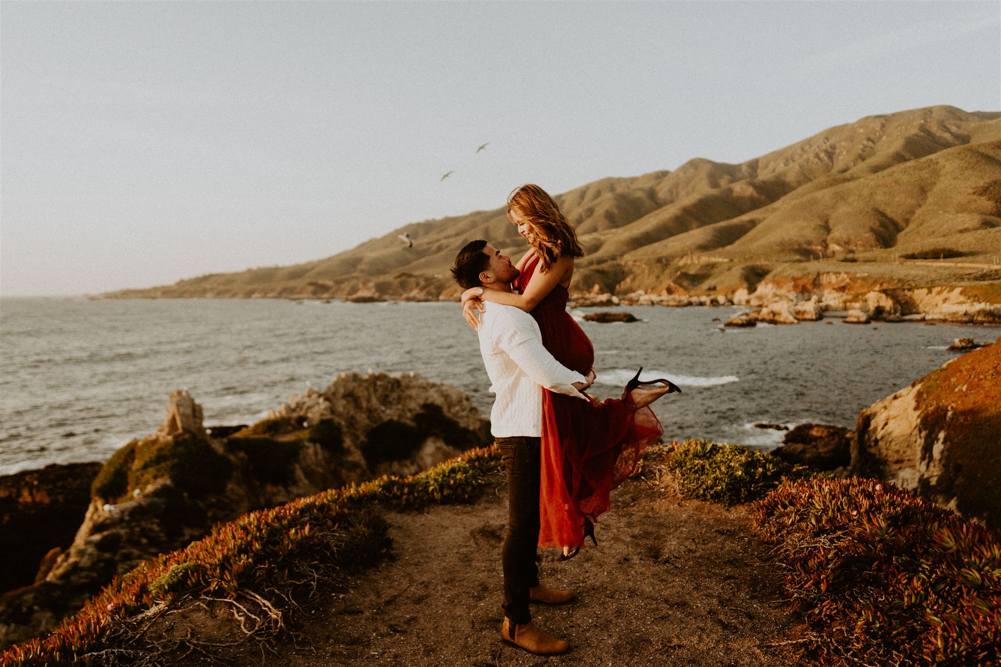 dreamy engagement session at big sur national park california with mountains and water in the background