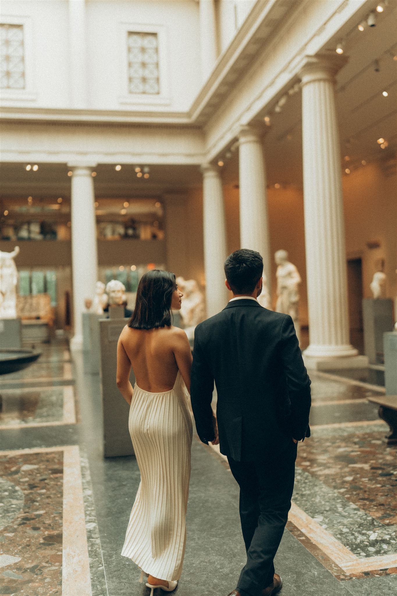 Metropolitan Museum of Art Engagement Photo of a couple walking through the exhibit